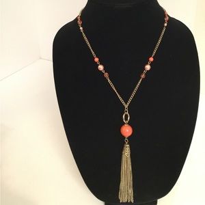 Beautiful Gold tone statement necklace with pink beads and gold tone tassel.